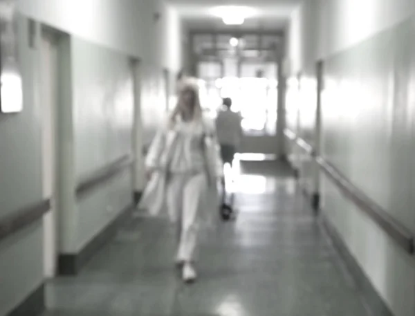 Doctors and nurses walking in hospital hallway, blurred motion. Stock Image