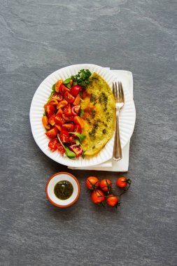 Omelette with arugula and tomatoes salad clipart
