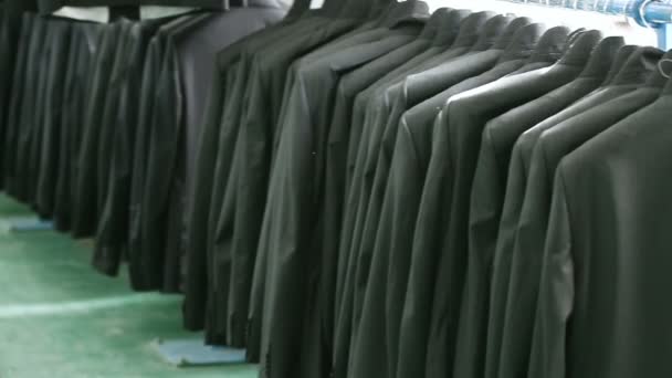 Black suits jacket hanging stacked on hanger. — Stock Video