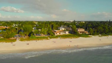 Drone flies along the coast over the water