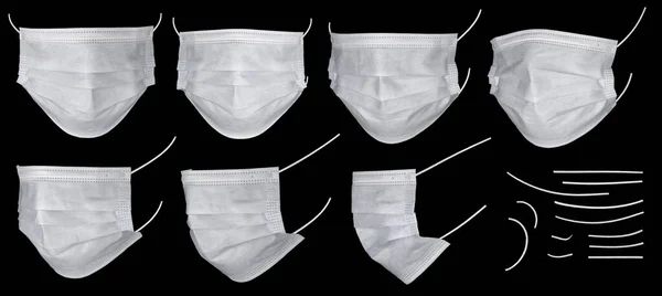 Tıbbi maske ya da cerrahi kulak ilmiği maskesi kesme yolu ile siyah arka planda izole edilmiş. Siyah üzerine beyaz tıbbi maskeler ve kırpma maskesi. Doktor maskesi koronovirüse karşı korur..