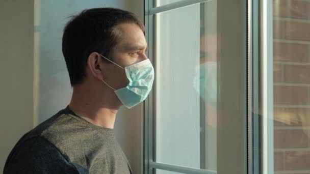Jongeman neemt een medisch masker af en haalt diep adem. — Stockvideo