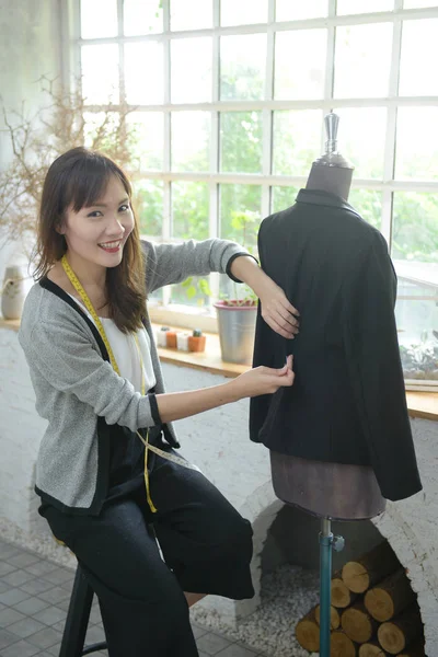 designer concept : Fashion designer working near mannequin in office