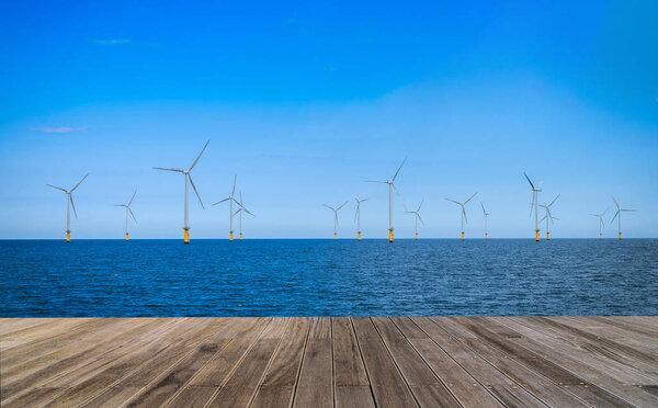 Offshore Wind Turbine in a Windfarm with wooden walkway under construction off the coast of England