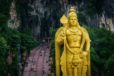 Statue of Lord Muragan and entrance at Batu Caves in Kuala Lumpur, Malaysia. clipart