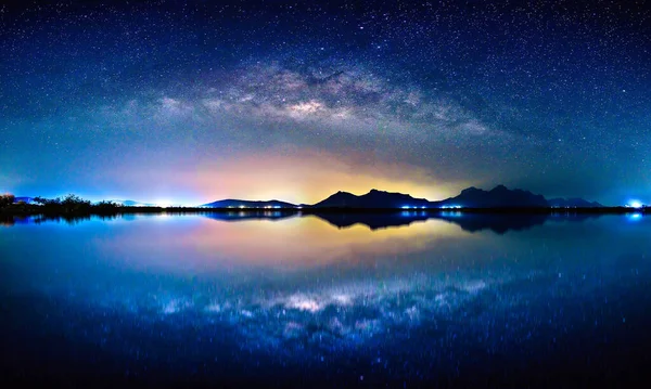 Landscape with Milky way galaxy. Night sky with stars over mountain and reflection on sea, Long exposure photograph.