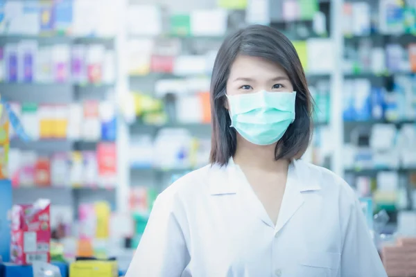 Asian women doctor with face mask with blurred background. Health Care Concept