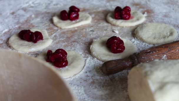 Cherry laying on the raw dough — Stock video