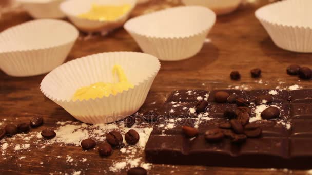 Main féminine met la pâte crue pour les muffins dans le papier de boulangerie — Video