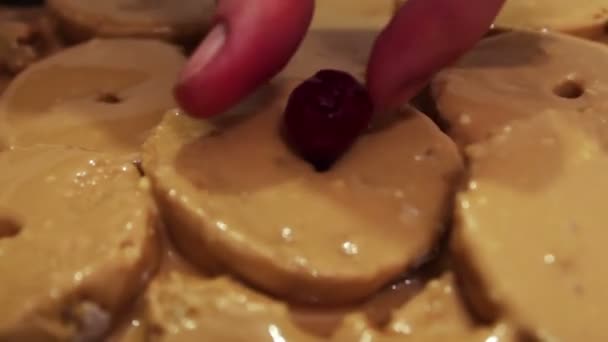 Woman decorate homemade cake with cherry — Stock Video