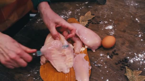 Manos femeninas cortando carne de pollo cruda — Vídeo de stock