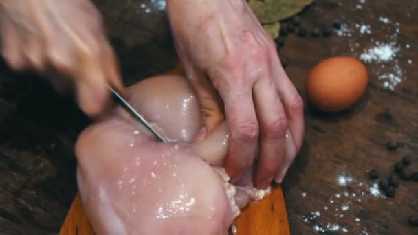 Weibliche Hände schneiden rohes Hühnerfleisch — Stockvideo