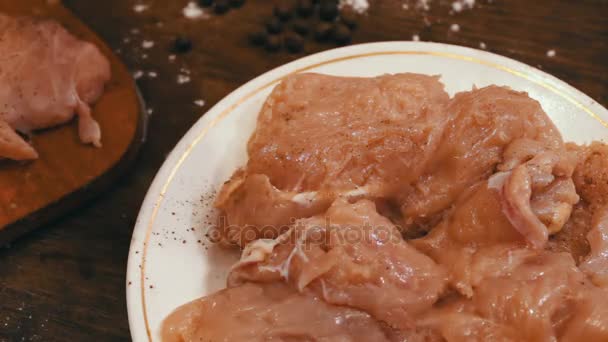 Chops of chicken sprinkled with salt and black pepper — Stock Video