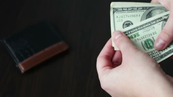 Womens hands holding a fan of hundred dollar bills and counts — Stock Video