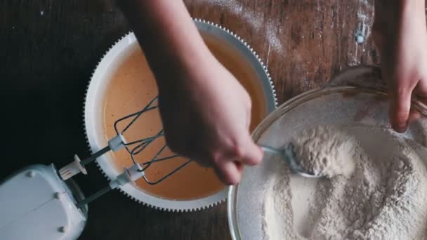 Vue du dessus de verse un verre de crème dans la pâte — Video