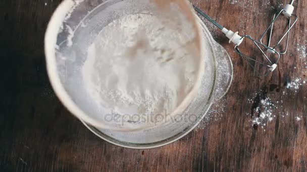 Top view of woman sieving flour in plate — Stock Video