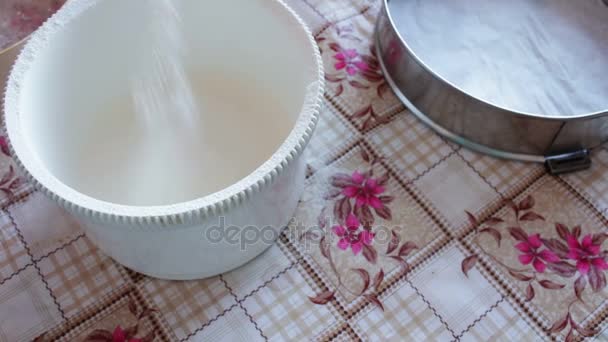 Woman pours flour into a bowl — Stock Video