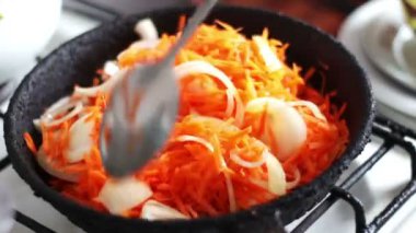 Eski bir tavada kızarmış soğan ve havuçları ilave edin