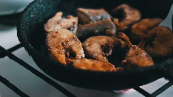 Fish fried in a frying pan until golden brown — Stock Video