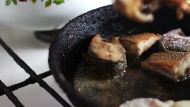 Pescado frito en una sartén torneado con un tenedor — Vídeos de Stock