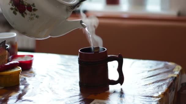 Boiling water is poured into a cup from the kettle — Stock Video