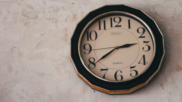 Horloge ronde suspendue sur un mur blanc — Video