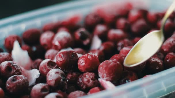 Many beautiful frozen cherries that try to take a vintage gilded spoon — Stock Video