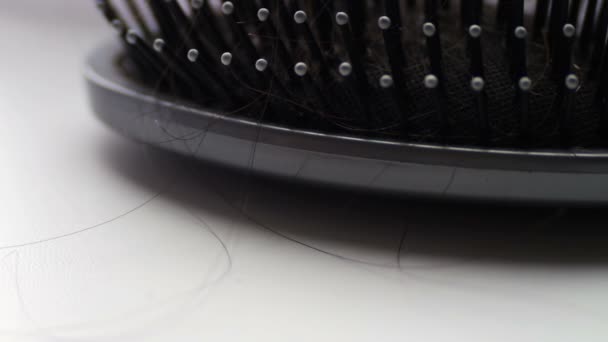 Women comb hair,hairbrush with hair extreme macro close up view, near black hair clips — Stock Video