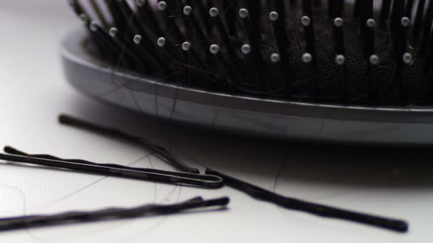 Women comb hair,hairbrush with hair extreme macro close up view, near black hair clips — Stock Video