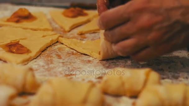 Μια γυναίκα βάζει στα φρέσκα κομμάτια της ζύμης βερίκοκο μαρμελάδα — Αρχείο Βίντεο