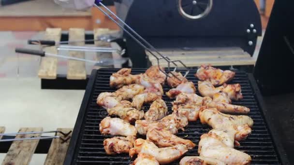 Chicken meat that turn over on a barbecue grill.Meat is fried in Mangal Barbecue grill. Chicken meat on the grill during a picnic — Stock Video