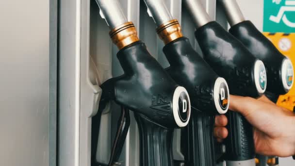 October 2, 2017 - Gorizia, Italy:mans hand takes a refueling gun to pour gasoline into the gas tank — Stock Video