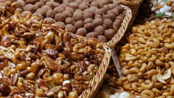 Mixture of dates dry fruits Raisins and nuts in the market La Boqueria in Barcelona,Spain — Stock Video