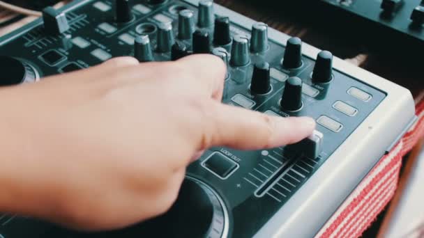 DJ console or mixer, the hand presses the levers and buttons of remote — Stock Video