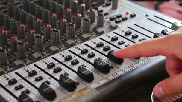 DJ console or mixer, the hand presses the levers and buttons of remote — Stock Video