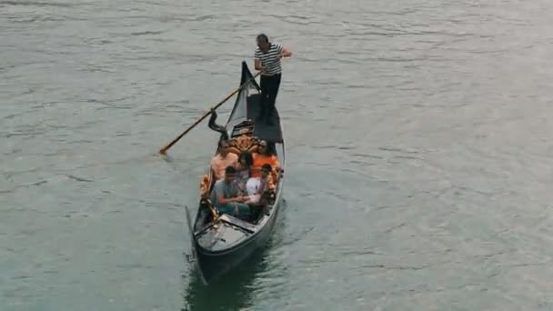 VENICE, ITALY, 7 СЕНТЯБРЯ 2017: гондольер катает туристов на гондоле по известному в мире Венецианскому Гранд Каналу — стоковое видео