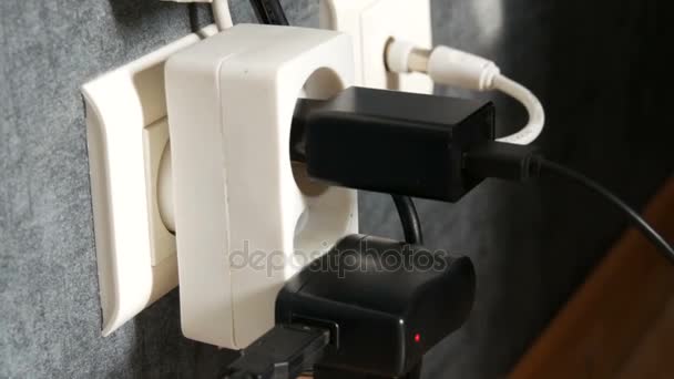 Many plugs in the wall outlet.Adapter charger in the wall outlet — Stock Video