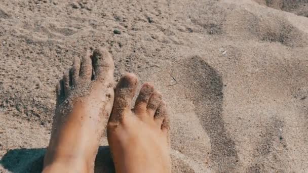 女性晒黑的腿和手指移动反对沙子的背景在海滩上 — 图库视频影像