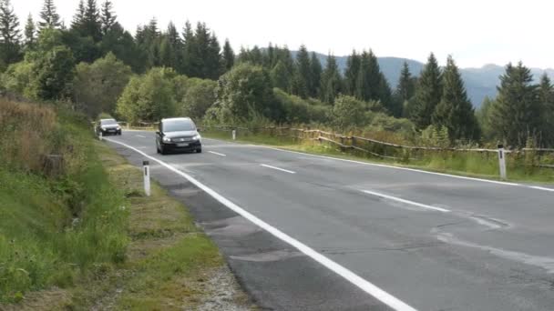September 8, 2017 - Unterterterl, Austria: bad patched road on which cars drive. Горная дорога с треснувшим асфальтом — стоковое видео