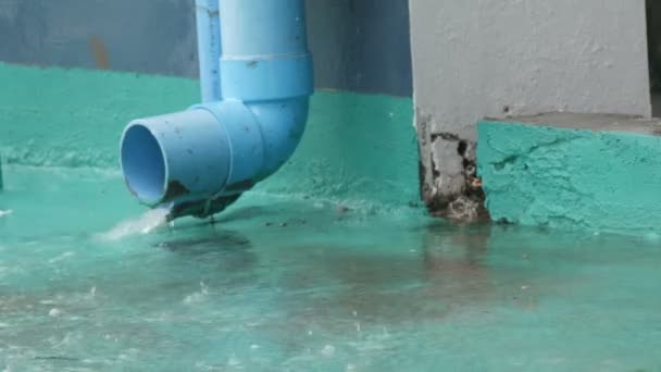 Gran tubo de lluvia azul a lo largo del cual drena la lluvia. Lluvias tropicales — Vídeo de stock