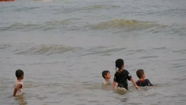 Pattaya, Thajsko, 14 prosince 2017: Thajské děti koupat v Jihočínském moři při západu slunce. Asijské děti frolicking na mořskou vodu — Stock video