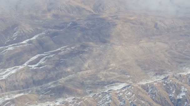 Mountain landscape with snow-capped peaks, view from airplane — Stock Video