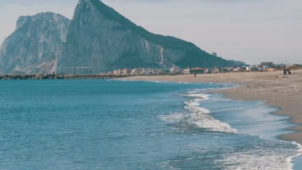 지중해의 아름 다운 파도, 하얀 모래와 바위 지브롤터의 배경 구타에 — 비디오