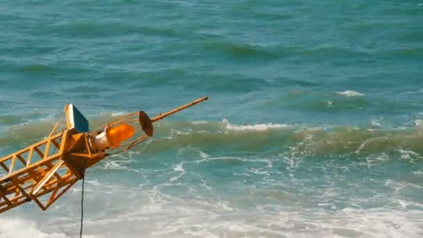 Large yellow buoy on the shore of the blue sea — Stock Video