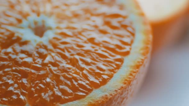 Gesneden oranje macro close-up op witte achtergrond — Stockvideo