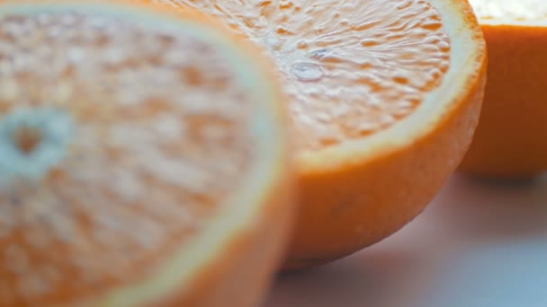Cut orange macro close up view on white background — Stock Video