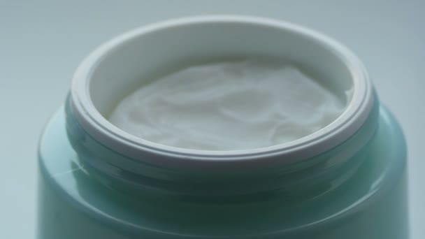 Frasco verde con la crema suave cosmética, el dedo femenino toca la crema de cerca vista. Crema macro digitación — Vídeos de Stock