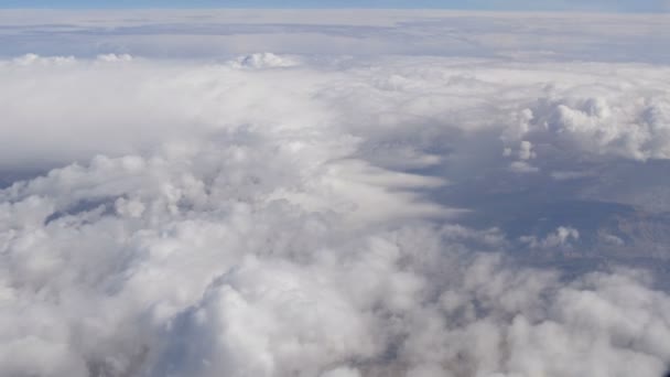 Variety of white fluffy clouds float across the sky, the view from the airplane — Stock Video