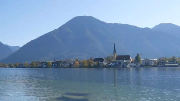 Bela igreja velha em lugar vibrante no fundo dos Alpes bávaros na costa do Lago Tegernsee — Vídeo de Stock