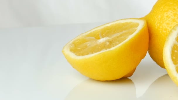 Ripe fresh juicy yellow lemon on white background. — Stock Video
